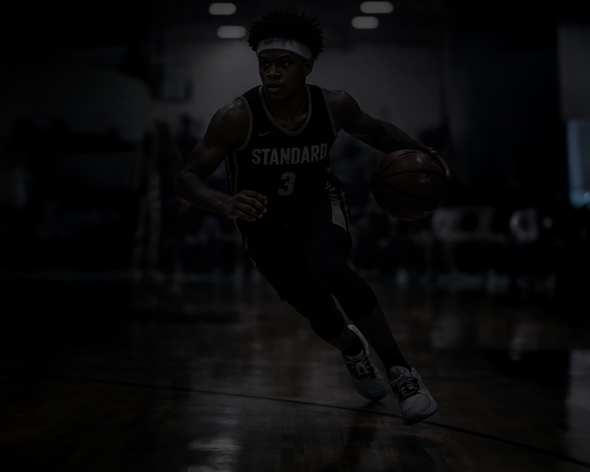 Elite Atlanta travel basketball player in Standard jersey dribbling on court